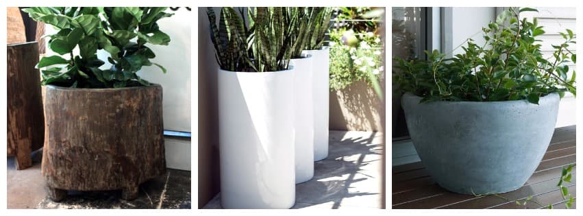 Outdoor planters, a rustic timber tub, tall white cylinders and a concrete bowl of greenery